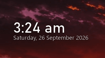 The clock on a dark wallpaper: two lines of white type showing a time and a date, with the wallpaper visible right up to the letters.